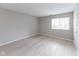 Bedroom featuring light hardwood flooring and a bright window at 1044 Timber Creek Dr # 4, Carmel, IN 46032