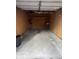 Spacious two car garage with unfinished plywood walls and shelving for ample storage and organization at 1044 Timber Creek Dr # 4, Carmel, IN 46032