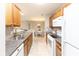 Galley-style kitchen shows appliances, cabinets and glimpse into the dining room at 1044 Timber Creek Dr # 4, Carmel, IN 46032