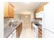 Galley-style kitchen shows appliances, cabinets and glimpse into the dining room at 1044 Timber Creek Dr # 4, Carmel, IN 46032