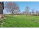 Expansive backyard with trees and a gentle slope, offering a serene outdoor environment at 10934 Haig Point Dr, Fishers, IN 46037