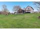 Large, well-maintained backyard with a home featuring a screened-in porch and lush lawn at 10934 Haig Point Dr, Fishers, IN 46037