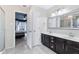 Bathroom featuring a double vanity, tiled flooring, and access to the bedroom at 10934 Haig Point Dr, Fishers, IN 46037