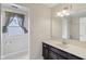 Bathroom with a sleek vanity, a large mirror, and neutral finishes at 10934 Haig Point Dr, Fishers, IN 46037