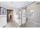 Bathroom featuring a jacuzzi tub, shower, and large window for natural light at 10934 Haig Point Dr, Fishers, IN 46037