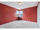 Bedroom features neutral carpeting, red accent walls and a corner window view at 10934 Haig Point Dr, Fishers, IN 46037