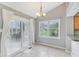 Bright dining area with a large window and sliding glass door for outdoor access at 10934 Haig Point Dr, Fishers, IN 46037