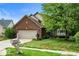 Charming two-story brick home with a well-manicured lawn and mature trees at 10934 Haig Point Dr, Fishers, IN 46037
