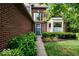 Inviting front entrance with a blue door, brick facade, and lush landscaping at 10934 Haig Point Dr, Fishers, IN 46037