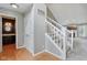 Hallway featuring wooden flooring and a staircase leading to the upper level at 10934 Haig Point Dr, Fishers, IN 46037
