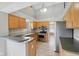 Well-lit kitchen with stainless steel appliances, tile flooring, and breakfast bar at 10934 Haig Point Dr, Fishers, IN 46037