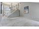 Spacious living room featuring high ceilings, staircase, and carpeted floor at 10934 Haig Point Dr, Fishers, IN 46037