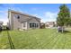 Spacious backyard with a playset, lush lawn, and garden beds, offering a serene outdoor environment at 11003 Liberation Trce, Noblesville, IN 46060