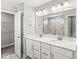 Bathroom with double sink vanity, a walk-in shower, and a linen closet at 11003 Liberation Trce, Noblesville, IN 46060