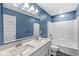 Stylish bathroom with double sink vanity, modern fixtures, and a bathtub with shower combination at 11003 Liberation Trce, Noblesville, IN 46060