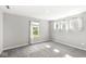 Bright bedroom with multiple windows and soft carpeting, offering natural light and a welcoming space at 11003 Liberation Trce, Noblesville, IN 46060