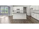 Modern kitchen with white cabinetry, stainless steel appliances, and an island with a sink at 11003 Liberation Trce, Noblesville, IN 46060
