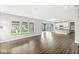 Spacious open concept living area with large windows and adjoining kitchen, ideal for entertaining at 11003 Liberation Trce, Noblesville, IN 46060