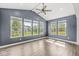 Bright sunroom with vaulted ceilings, a ceiling fan, and many windows overlooking the backyard at 11003 Liberation Trce, Noblesville, IN 46060