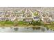 Aerial view of homes in a neighborhood near a pond with flowering trees lining the streets at 11182 Black Gold Dr, Noblesville, IN 46060