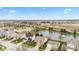 Expansive aerial view of homes surrounding a pond, showcasing the neighborhood's layout and landscaping at 11182 Black Gold Dr, Noblesville, IN 46060
