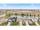 Scenic aerial shot of homes near a pond, with construction in the background, under a blue sky at 11182 Black Gold Dr, Noblesville, IN 46060