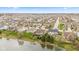 Wide aerial shot of a residential area showcasing homes near a pond and blossoming trees at 11182 Black Gold Dr, Noblesville, IN 46060