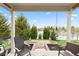 Relax on this cozy covered back porch overlooking the tranquil lake at 11182 Black Gold Dr, Noblesville, IN 46060