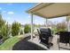 Covered back porch area with grill overlooking large yard and pond at 11182 Black Gold Dr, Noblesville, IN 46060