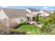 A well-maintained backyard featuring a cozy patio, fire pit, and lush landscaping at 11182 Black Gold Dr, Noblesville, IN 46060