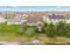 Aerial view featuring a well-kept backyard with lush greenery and patio area overlooking a tranquil pond at 11182 Black Gold Dr, Noblesville, IN 46060