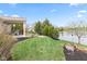 Spacious backyard featuring a covered porch area and tranquil lake views at 11182 Black Gold Dr, Noblesville, IN 46060