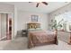 Bedroom featuring large window, bed and side table with decorative plants and wall art at 11182 Black Gold Dr, Noblesville, IN 46060