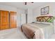 Bedroom featuring a large bed, wooden armoire, and neutral walls with a calming ambiance at 11182 Black Gold Dr, Noblesville, IN 46060