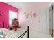 Bright bedroom showcasing pink walls and an assortment of colorful decorations and dollhouse at 11182 Black Gold Dr, Noblesville, IN 46060