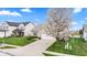 Charming home featuring a well-manicured lawn, concrete driveway, and a beautiful flowering tree at 11182 Black Gold Dr, Noblesville, IN 46060