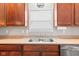 Close-up of the kitchen sink area with stainless steel sink and wood cabinets at 11182 Black Gold Dr, Noblesville, IN 46060