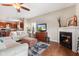 Open-concept living room with a fireplace and TV, connected to the kitchen for seamless living at 11182 Black Gold Dr, Noblesville, IN 46060