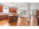 Open-concept design connecting the kitchen and living room, showcasing the hardwood floors and fireplace at 11182 Black Gold Dr, Noblesville, IN 46060