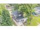 Aerial shot displays the home, backyard deck, mature trees, and the surrounding neighborhood at 1139 E 35Th St, Indianapolis, IN 46205