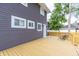 Expansive backyard deck with outdoor seating, freshly painted railings, and access to home via back door at 1139 E 35Th St, Indianapolis, IN 46205