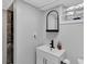 Modern bathroom with a sleek black faucet and a stylish arched mirror above the white sink at 1139 E 35Th St, Indianapolis, IN 46205