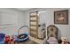 A cozy bedroom or playroom with a trampoline and view into living room at 1139 E 35Th St, Indianapolis, IN 46205