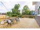 Expansive wooden deck furnished with wicker chairs, pillows, and a serene view of the backyard at 1139 E 35Th St, Indianapolis, IN 46205