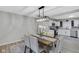 Well-lit dining room with a modern chandelier and updated kitchen in the background at 1139 E 35Th St, Indianapolis, IN 46205