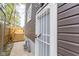 Side view of a home's exterior and backyard deck secured with a white security door at 1139 E 35Th St, Indianapolis, IN 46205