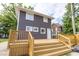 Two-story home with brown siding, a large wooden deck, and steps leading to a backyard at 1139 E 35Th St, Indianapolis, IN 46205