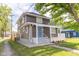 Two-story home showcasing the side of the house, driveway, and manicured lawn at 1139 E 35Th St, Indianapolis, IN 46205