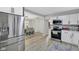 View of the kitchen with stainless steel appliances that leads into the dining area at 1139 E 35Th St, Indianapolis, IN 46205