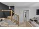 Staircase with black metal railings leads into a living room with light-colored walls and wooden floors at 1139 E 35Th St, Indianapolis, IN 46205
